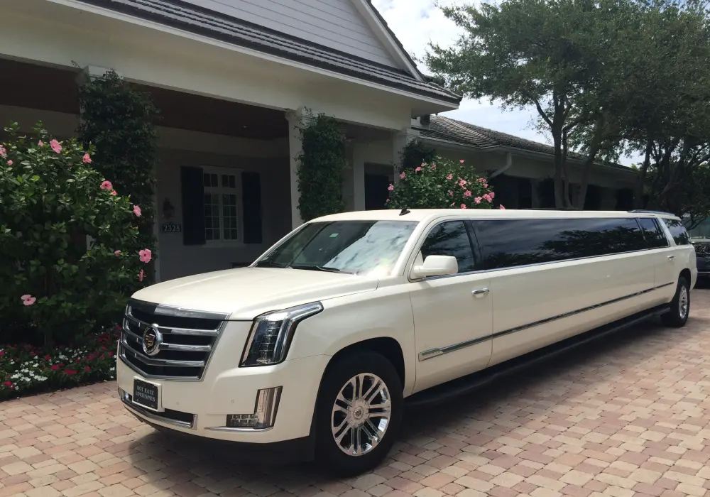 a white limousine parked in front of a house