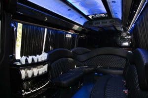 Executive Sprinter interior with blue LED ceiling, glassware bar, and diamond-stitched leather seating