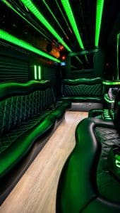 14 passenger Mercedes-Benz Sprinter party interior with green LED lighting and wrap-around leather seating