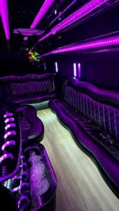 14 passenger Mercedes-Benz Sprinter interior with purple LED lighting, starlight ceiling, lit bar and diamond-stitched leather
