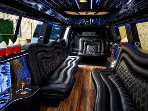 Wrap-around leather seating, hardwood floor, and LED lighting inside the 18 passenger stretch limo