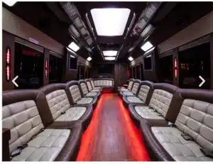 Wraparound seating and red LED floor lighting inside the 35 passenger party bus