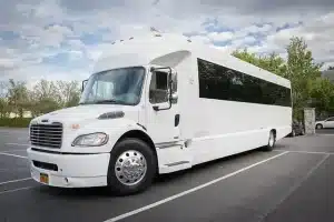 Front view of the white 35 passenger party bus with tinted windows